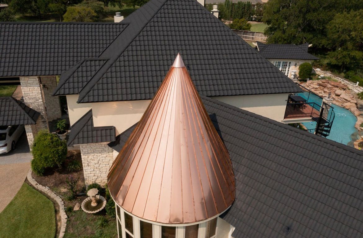 An aerial view of a house with a copper roof