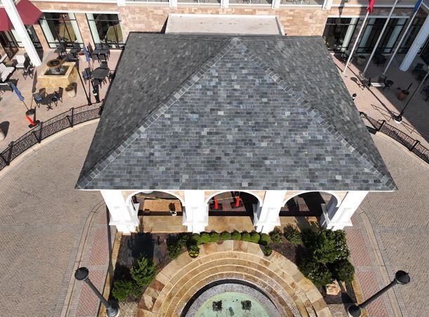 An aerial view of a gazebo with a fountain in front of it