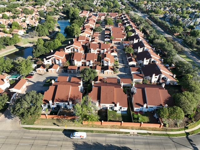 An aerial view of a commercial area with red roofs.