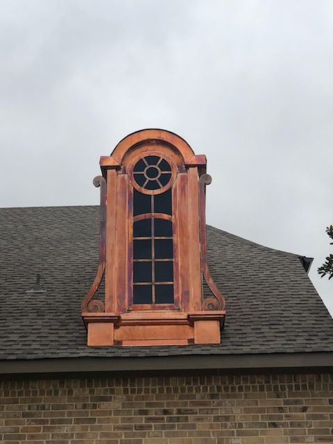 A brick building with a window on top of it