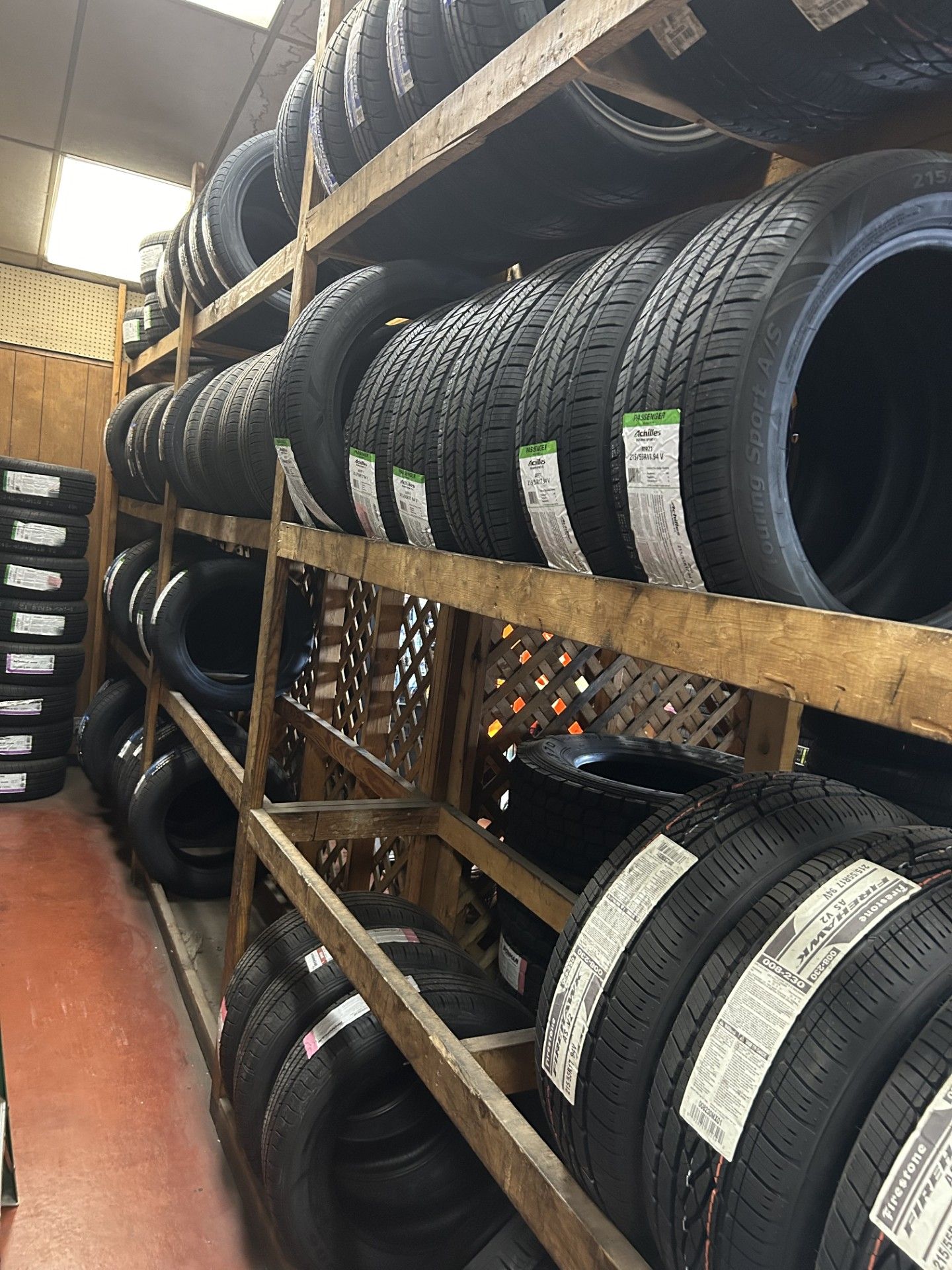 A warehouse filled with lots of tires on shelves.