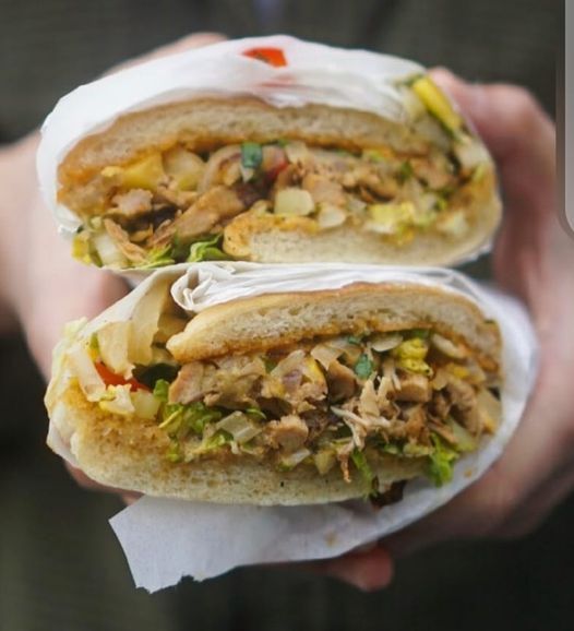 Two sandwiches in their hands