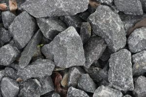 A pile of rocks sitting on top of each other on the ground.