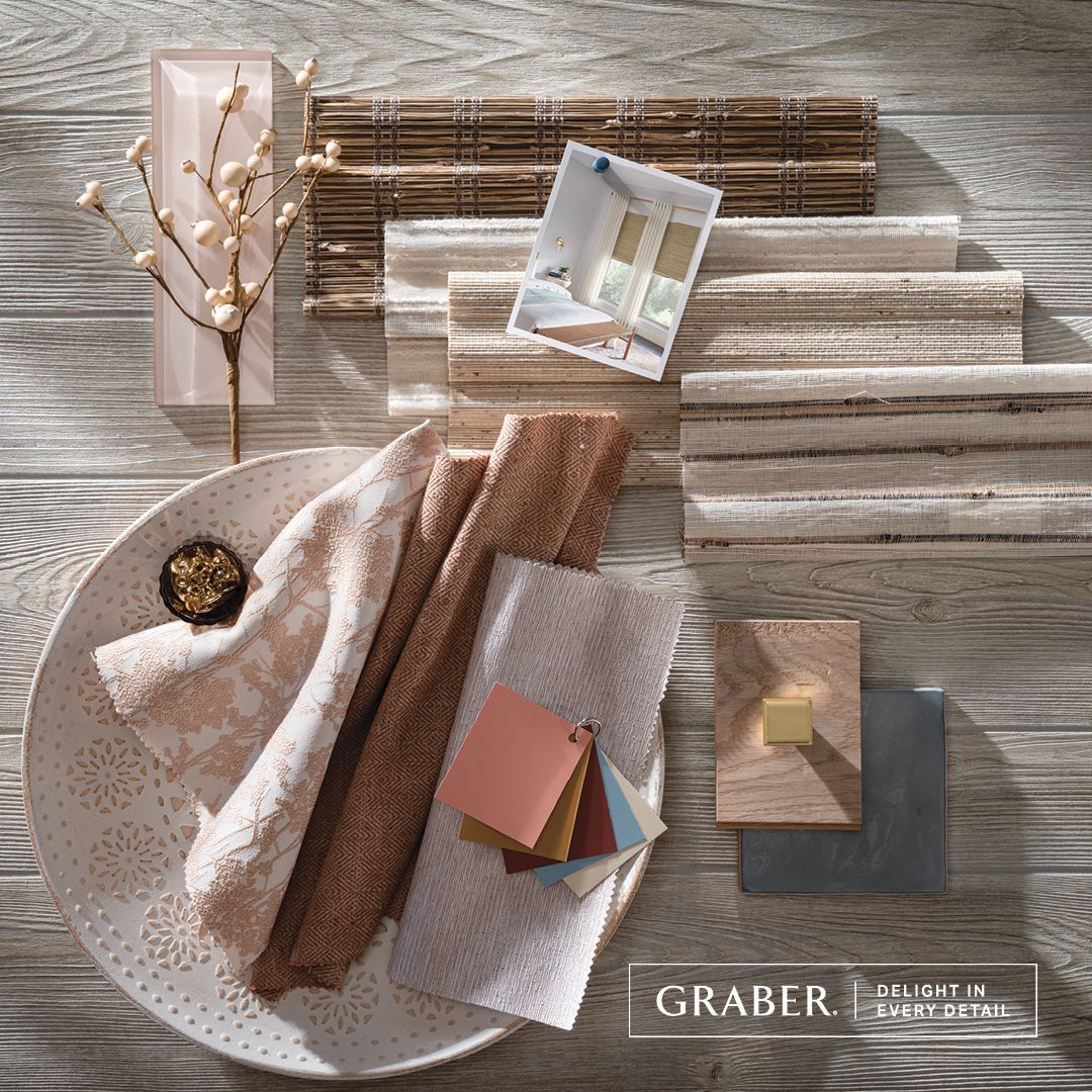 Arranged interior design elements in neutral tones: fabric swatches, wood tiles, and decorative accents on a wood background.