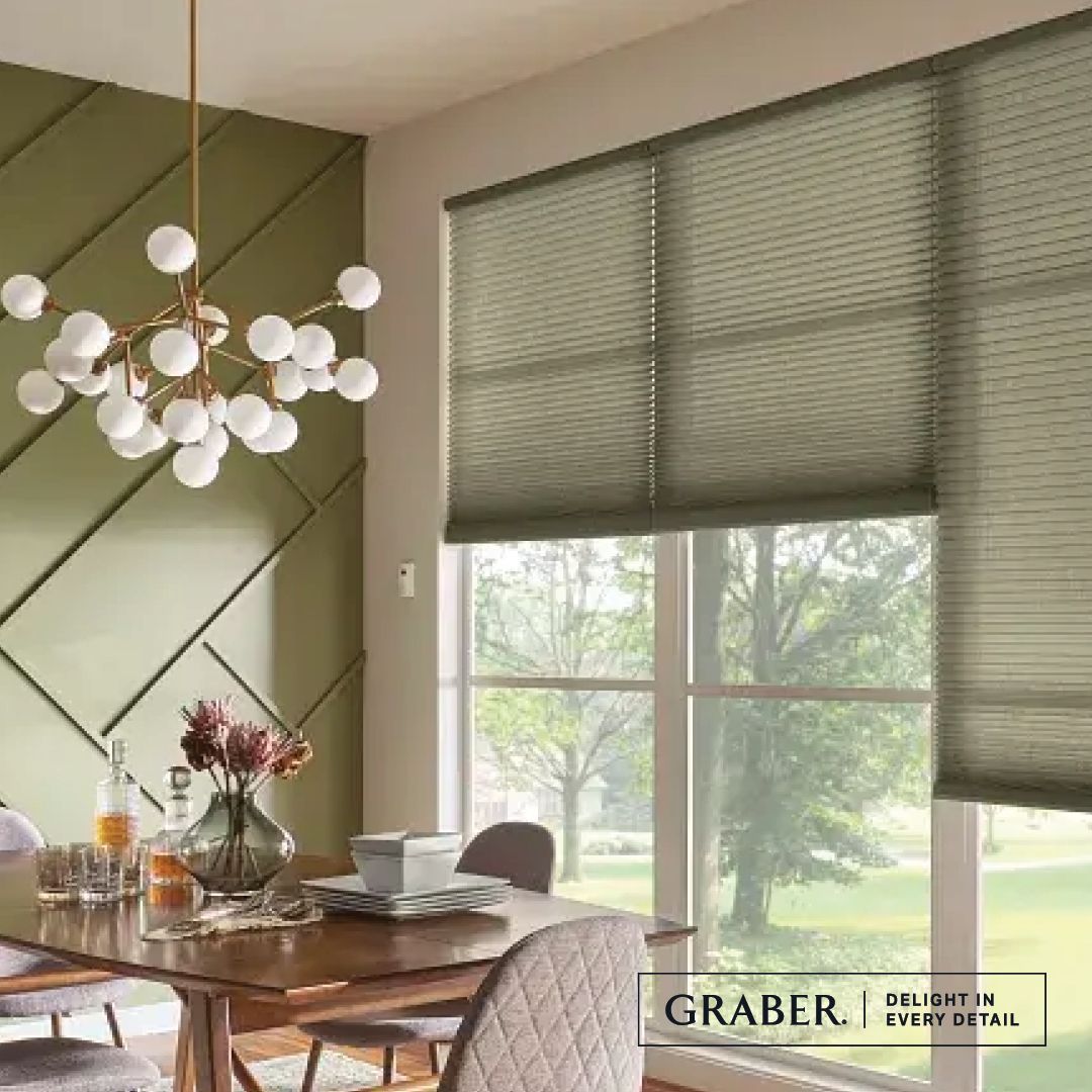 Dining room with table, chairs, blinds, and a decorative wall.