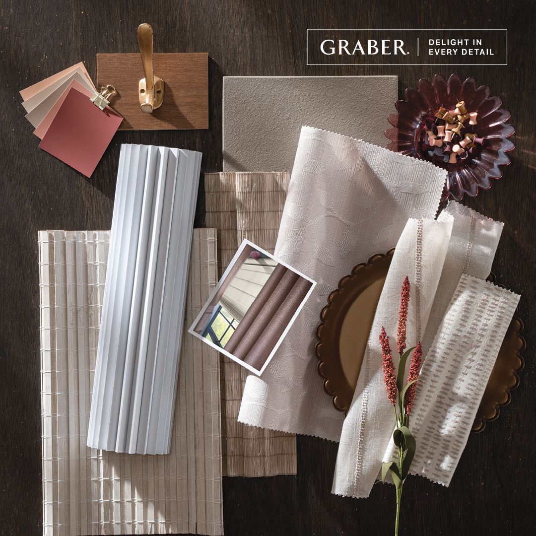 Graber fabrics and samples arranged on wood. Includes shades of beige, white, and red, plus an image of a window.