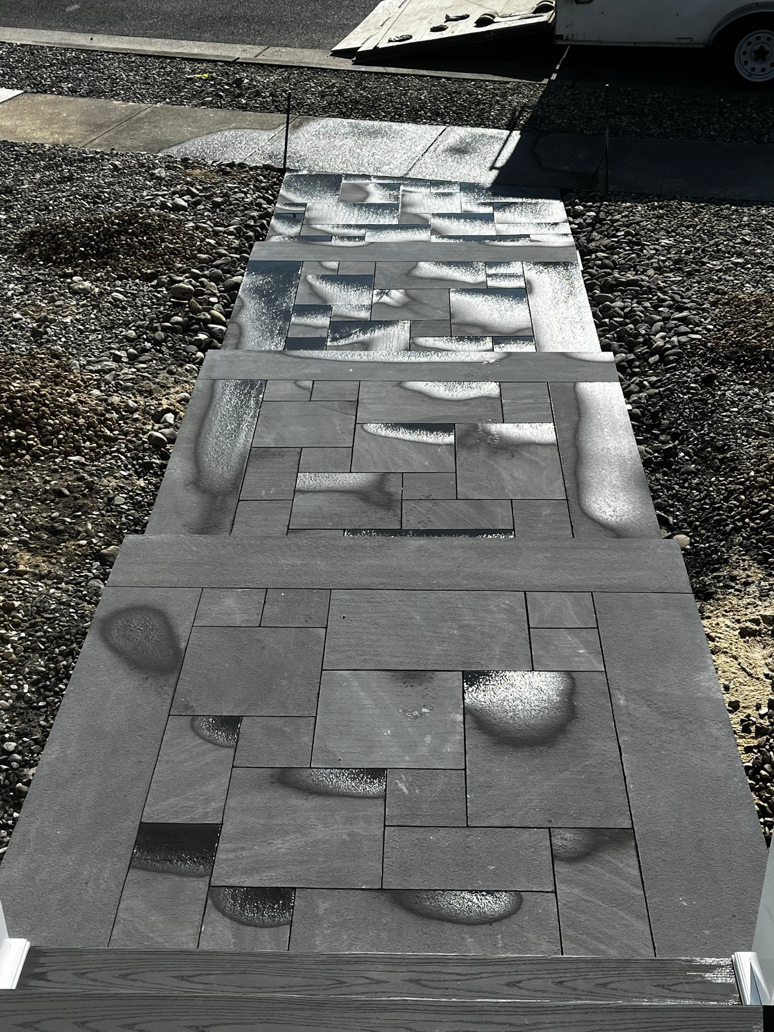 Stone steps leading up, grey, with irregular shapes and water spots.