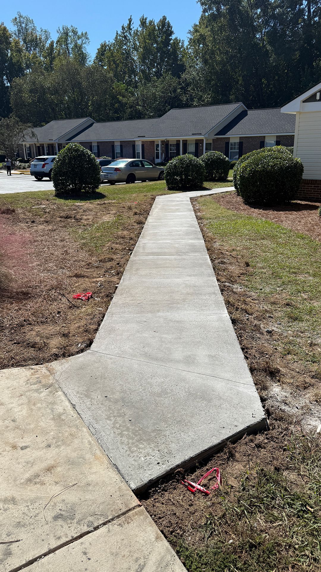 Concrete sidewalk leading to apartments