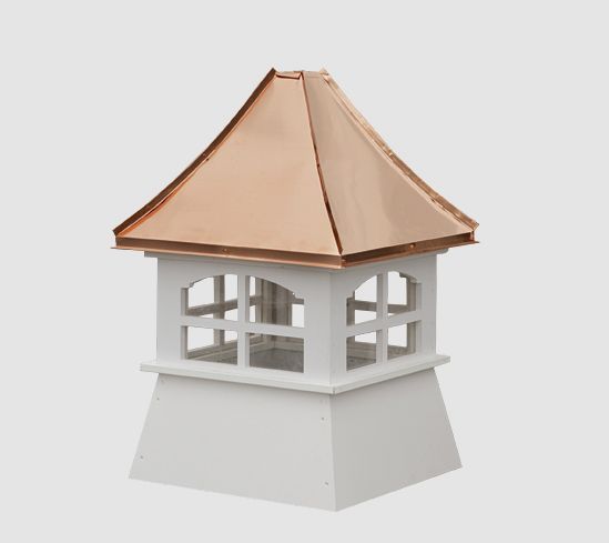 a small white building with a copper roof