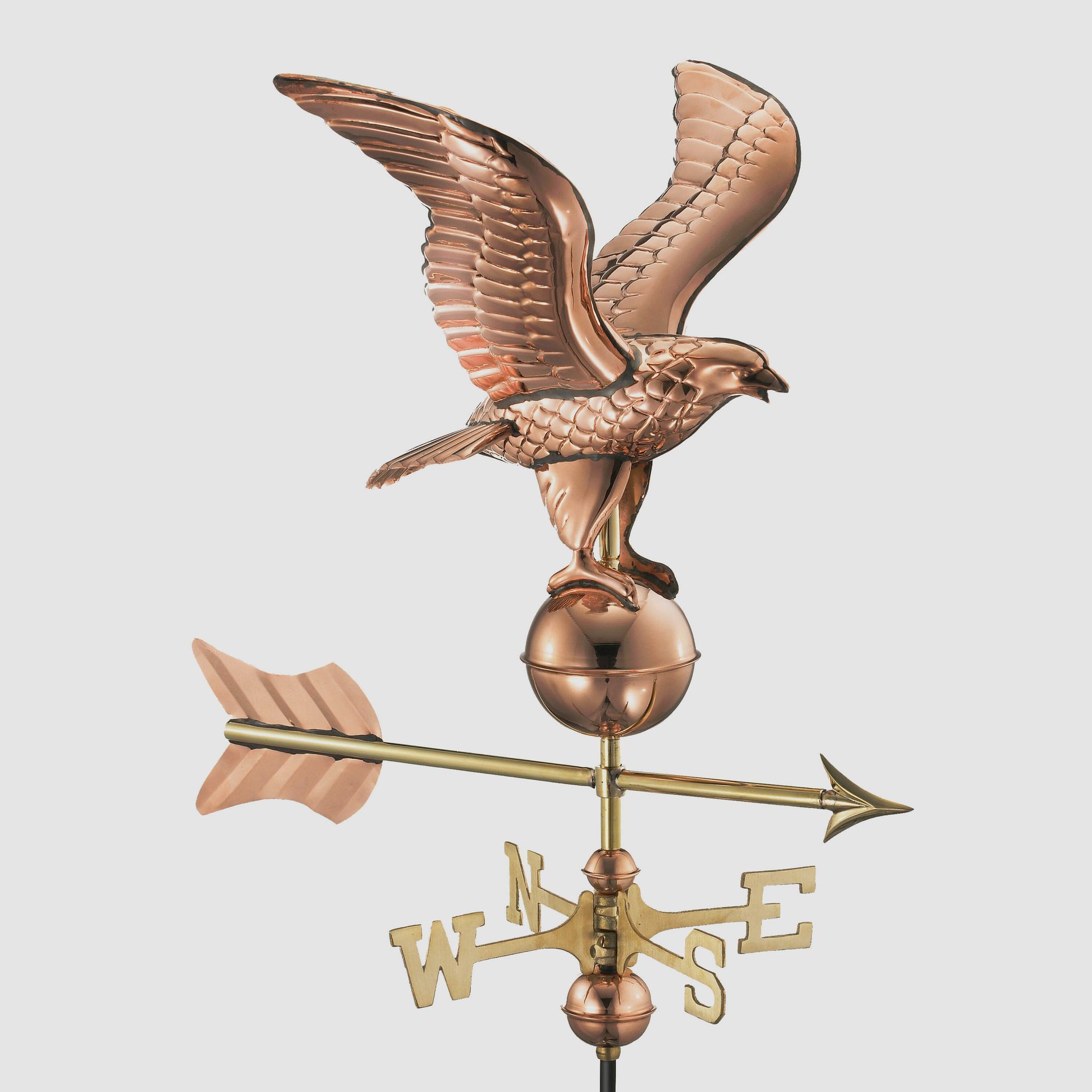a copper weather vane with an eagle on top of it