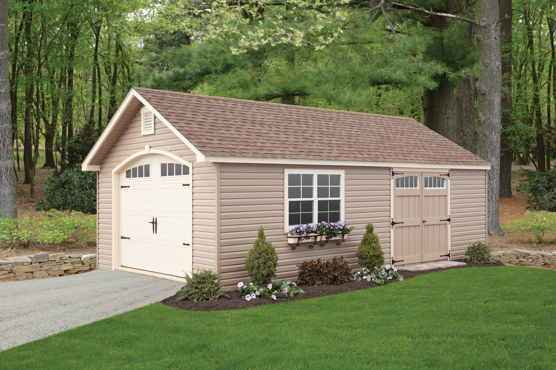 a garage with a brown roof is in the middle of a lush green yard .