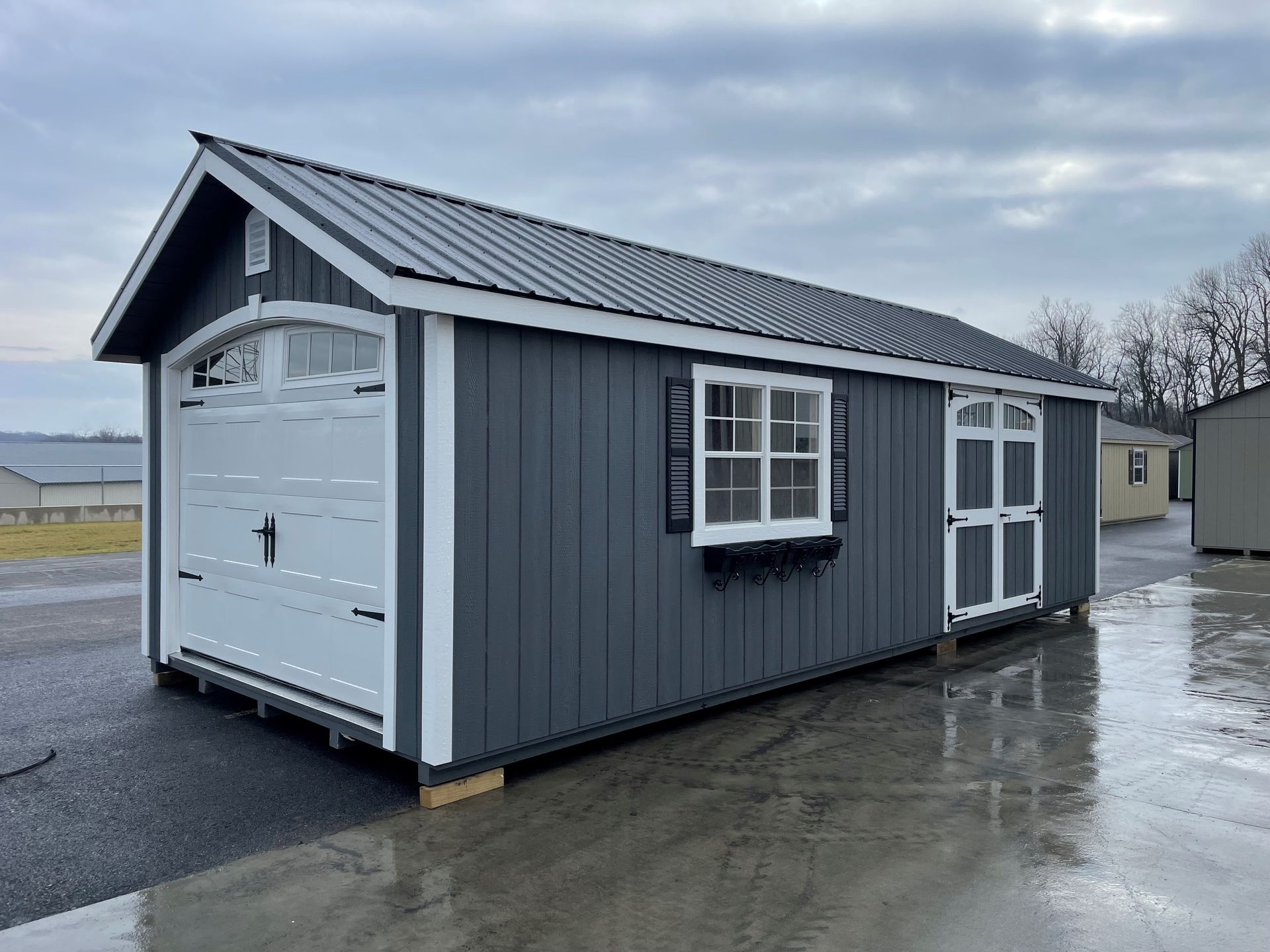 a small shed with a garage door and a window .