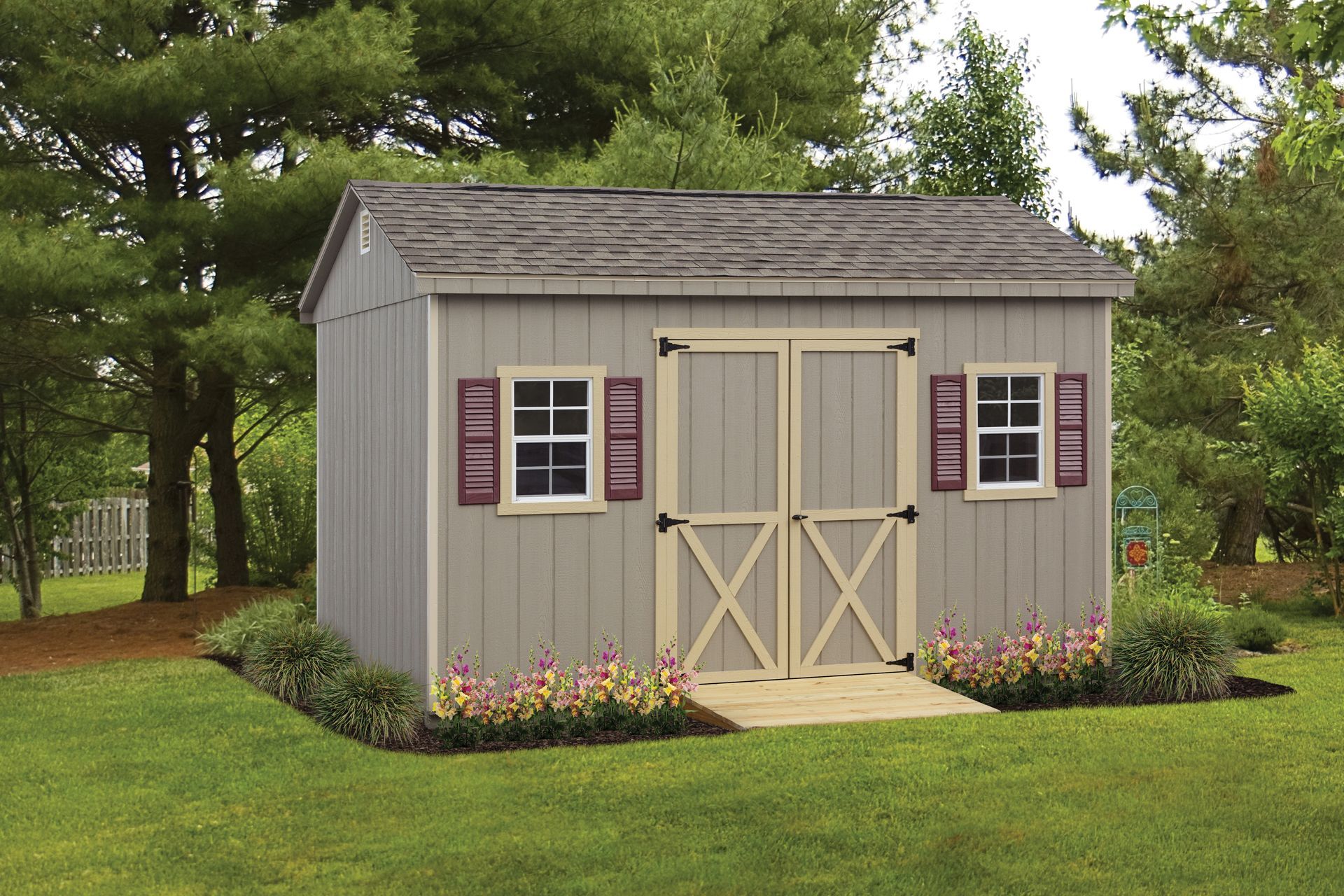 a gray shed with purple shutters is in the middle of a lush green yard