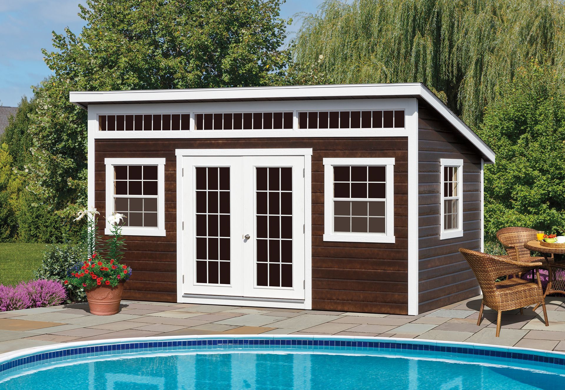 a brown and white shed sits next to a swimming pool
