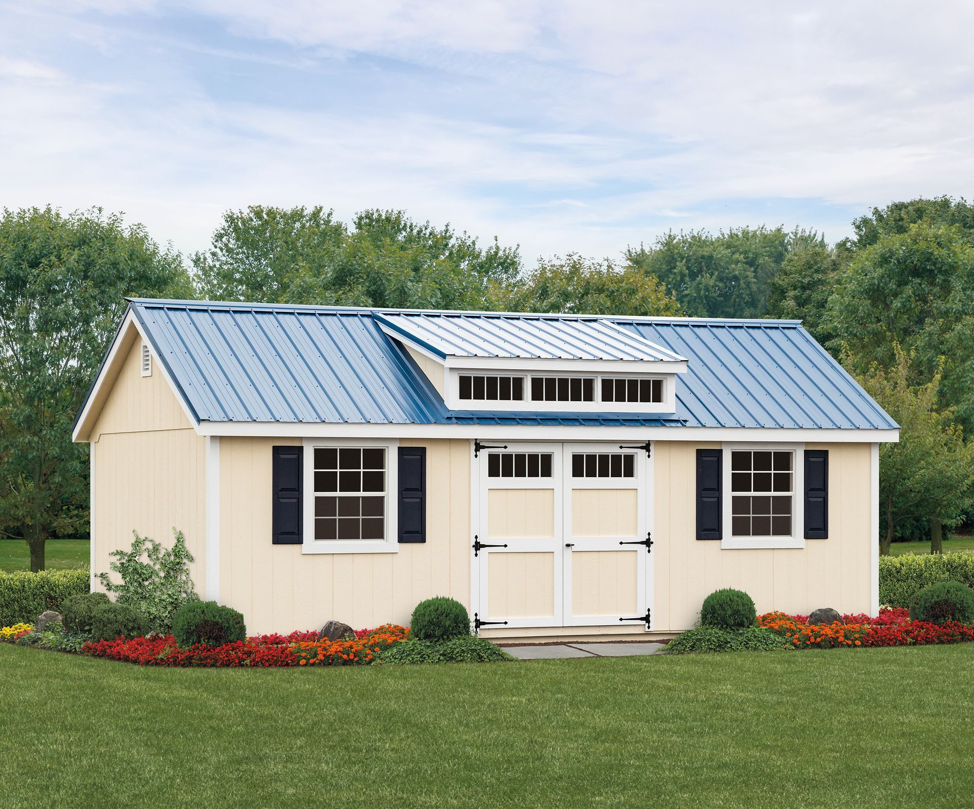 a small house with a blue roof and black shutters