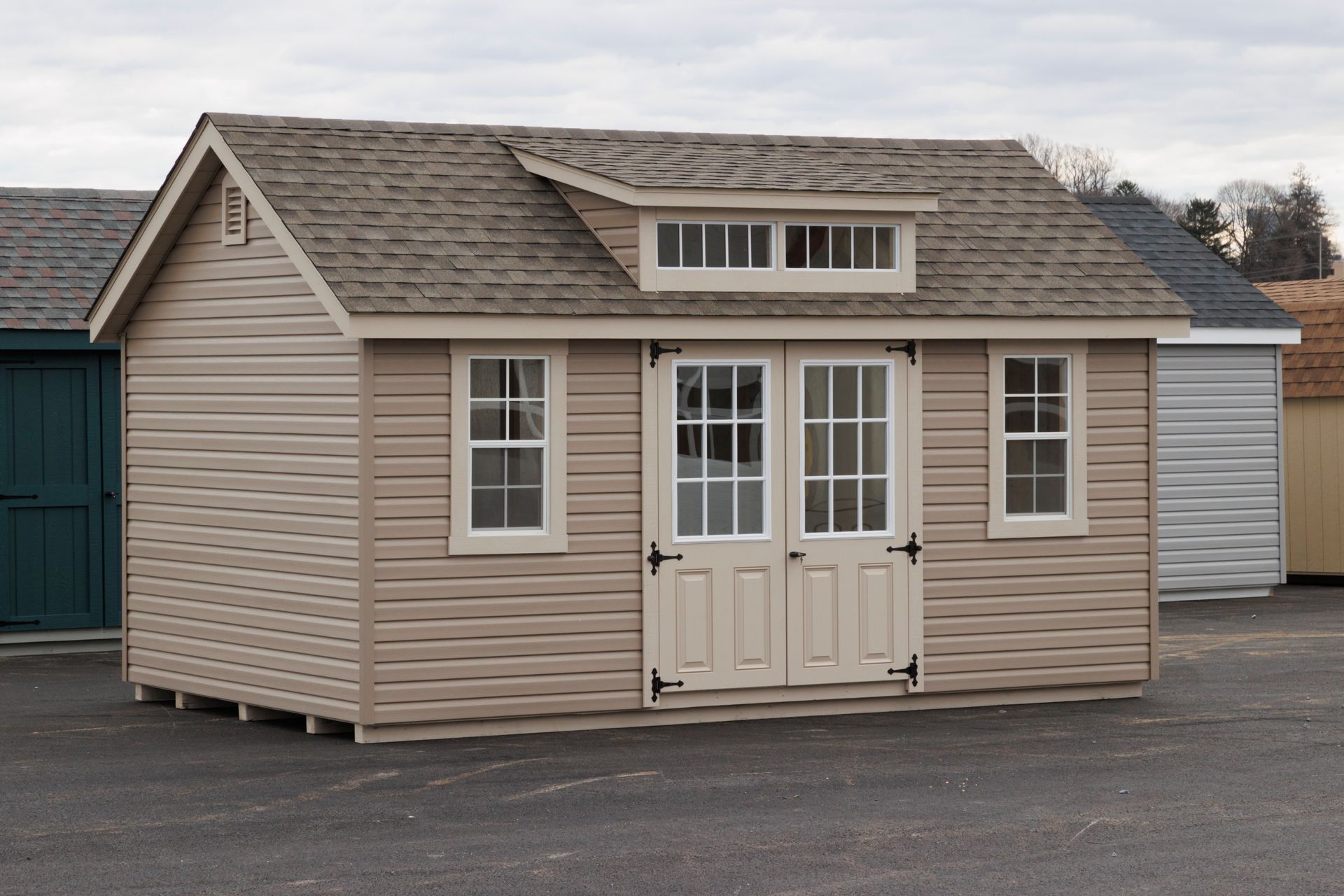 a shed with a roof that has a window on top of it