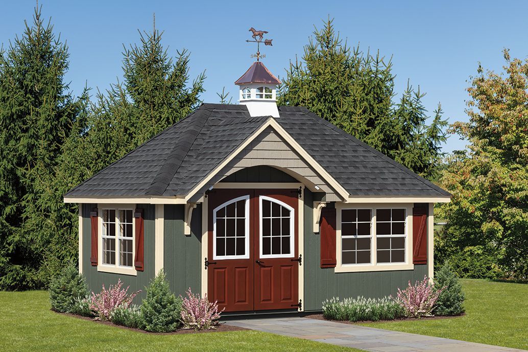 a small house with a weather vane on top of it .