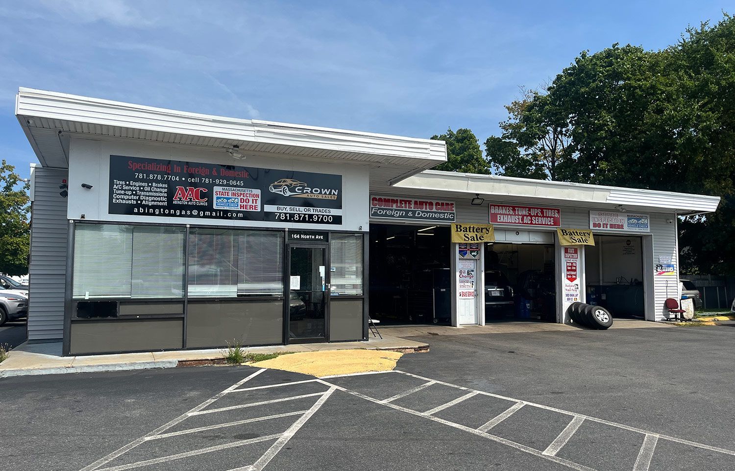 A car repair shop with a lot of cars parked in front of it.