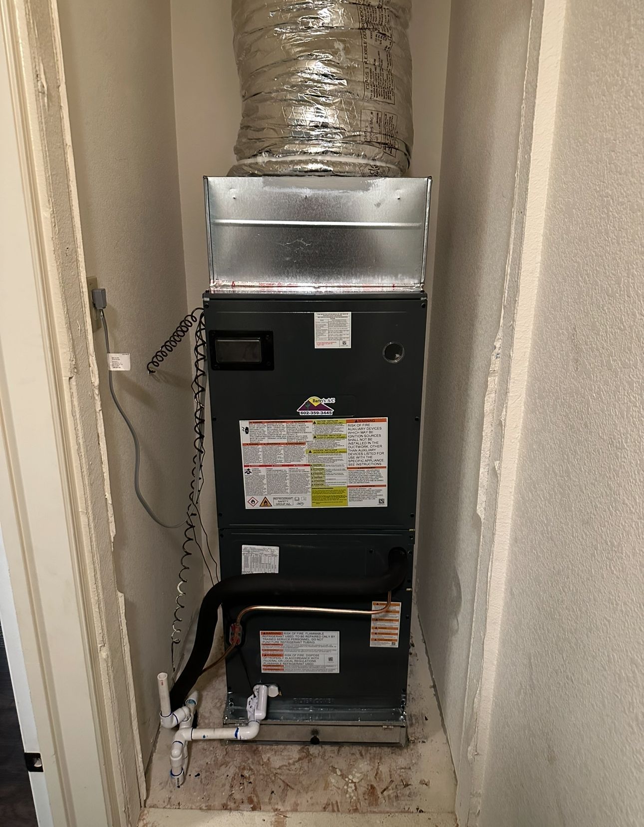 A central HVAC unit inside a closet, with ductwork and various labels visible.