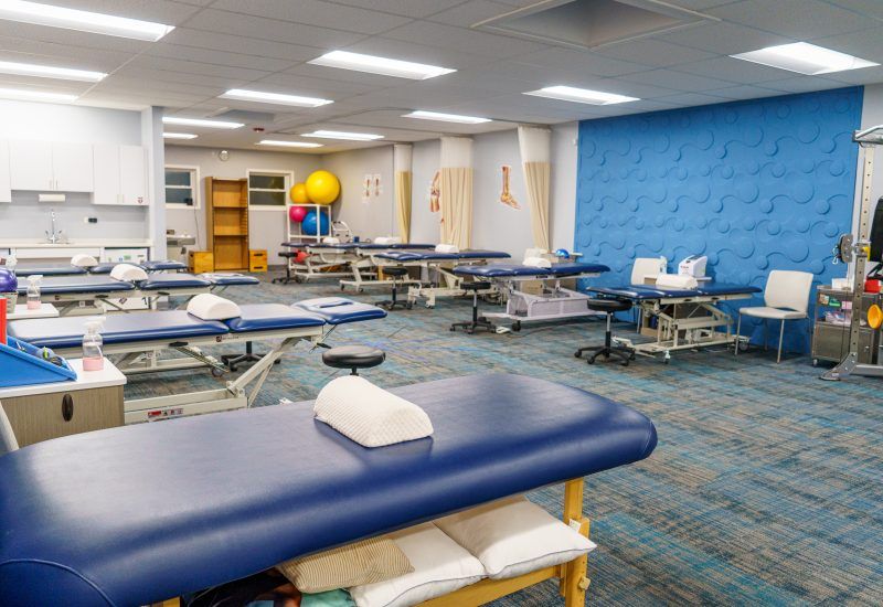 A large room filled with lots of blue tables and chairs