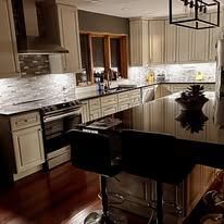 Kitchen with cabinets, island, and appliances in a home setting.
