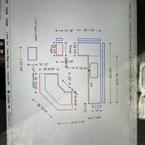 Diagram of a custom desk, with dimensions and measurements labeled in red and black lines.