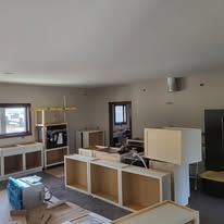 Kitchen remodel in progress, featuring unfinished cabinets and countertops.