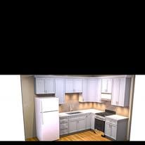 Kitchen with white cabinets, refrigerator, stove, and sink.