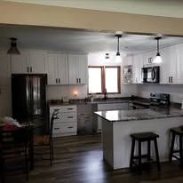 Kitchen interior with white cabinets, island, and appliances.