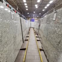 Large slabs of stone in a warehouse aisle.
