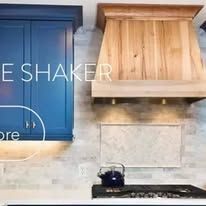 Blue cabinet and wooden range hood above a stovetop.