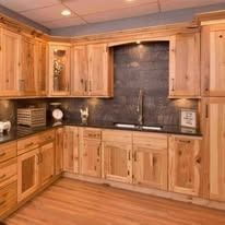 Kitchen with wooden cabinets, countertop, and a backsplash.