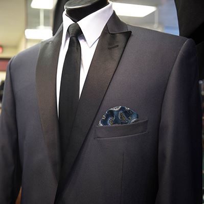 A man in a tuxedo with a pocket square in his pocket