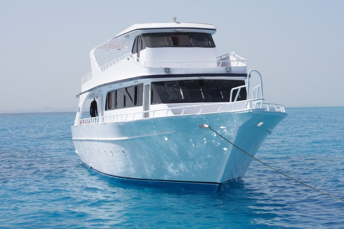 A white boat is floating on top of a blue ocean.