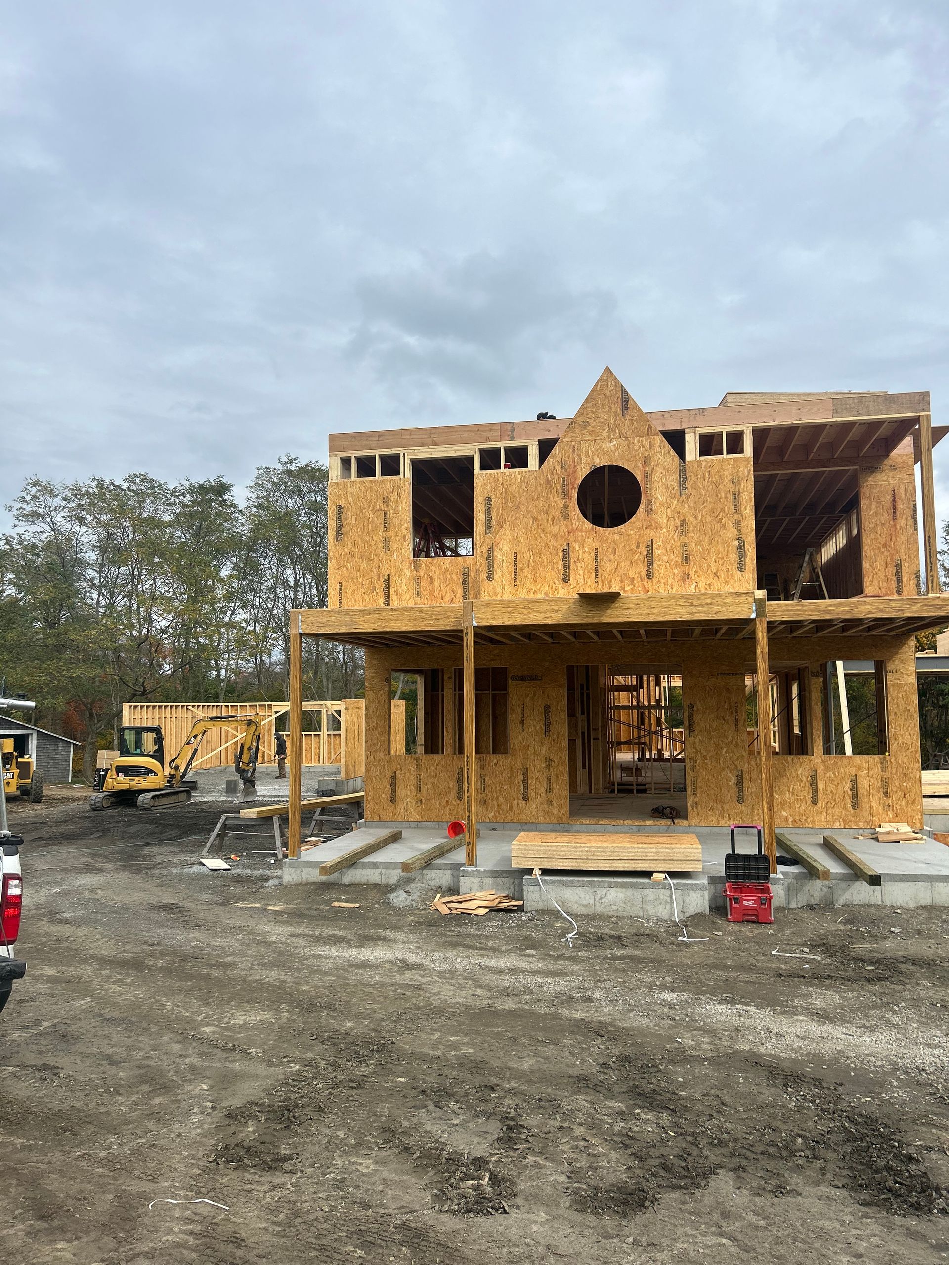A house is being built in the middle of a dirt field.