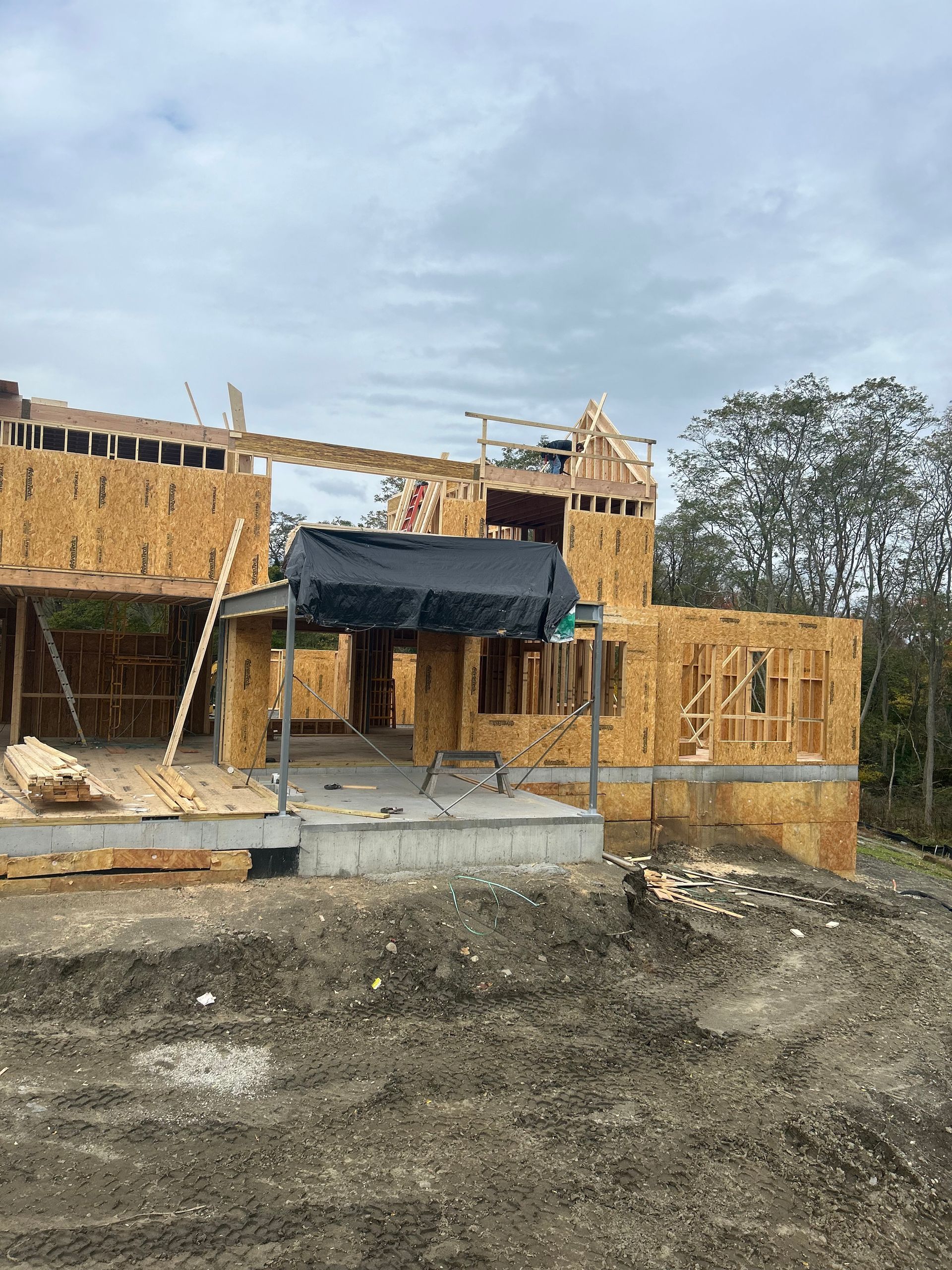 A house is being built in the middle of a dirt field.