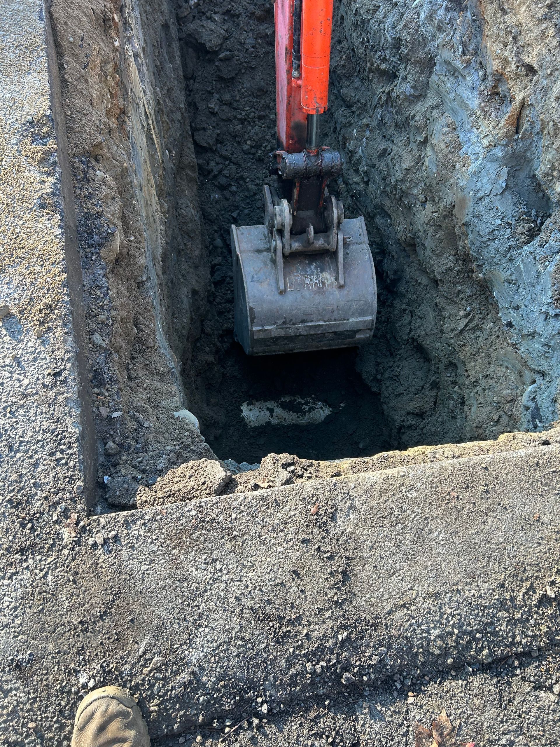 An excavator is digging a hole in the ground.