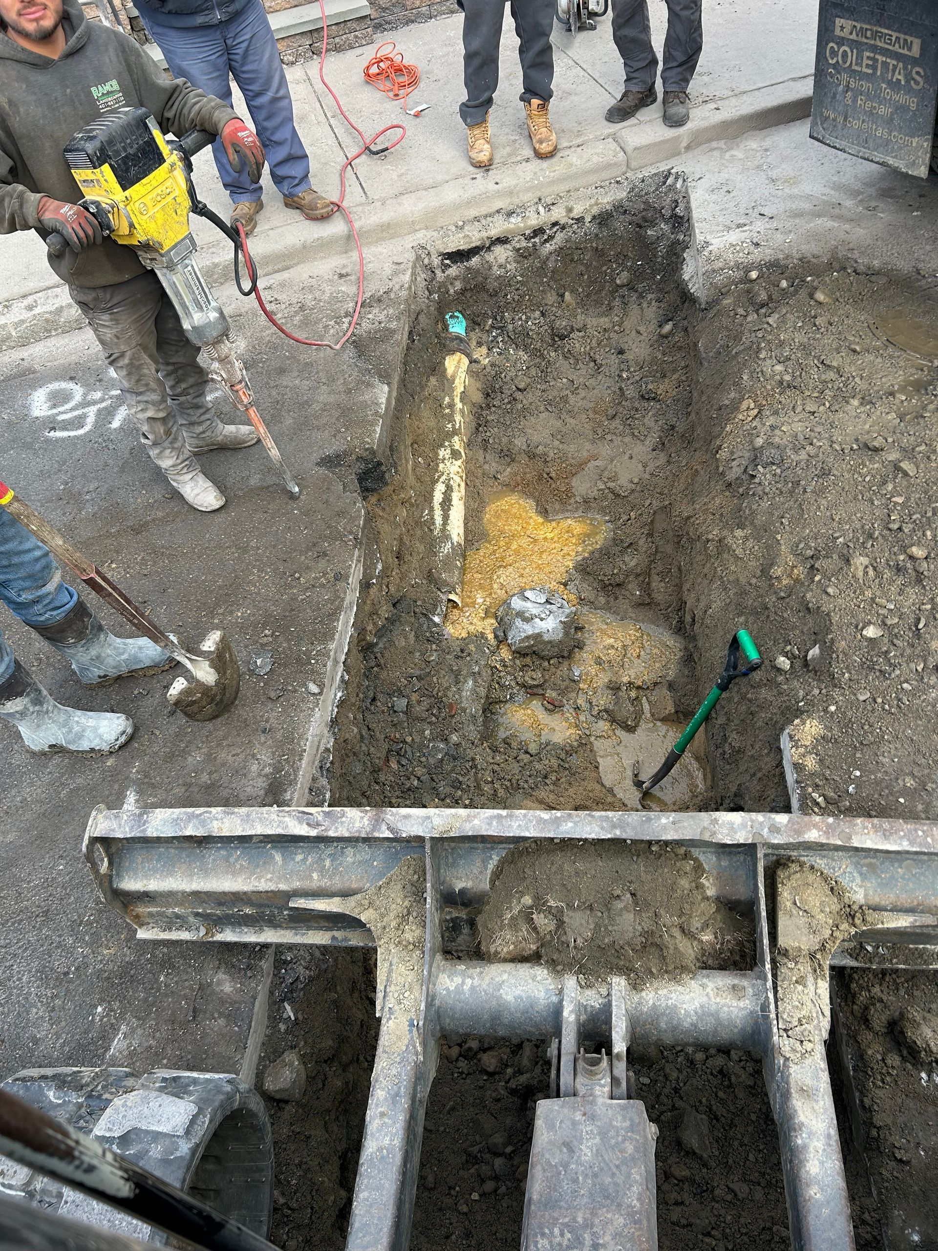 A group of construction workers are digging a hole in the ground.