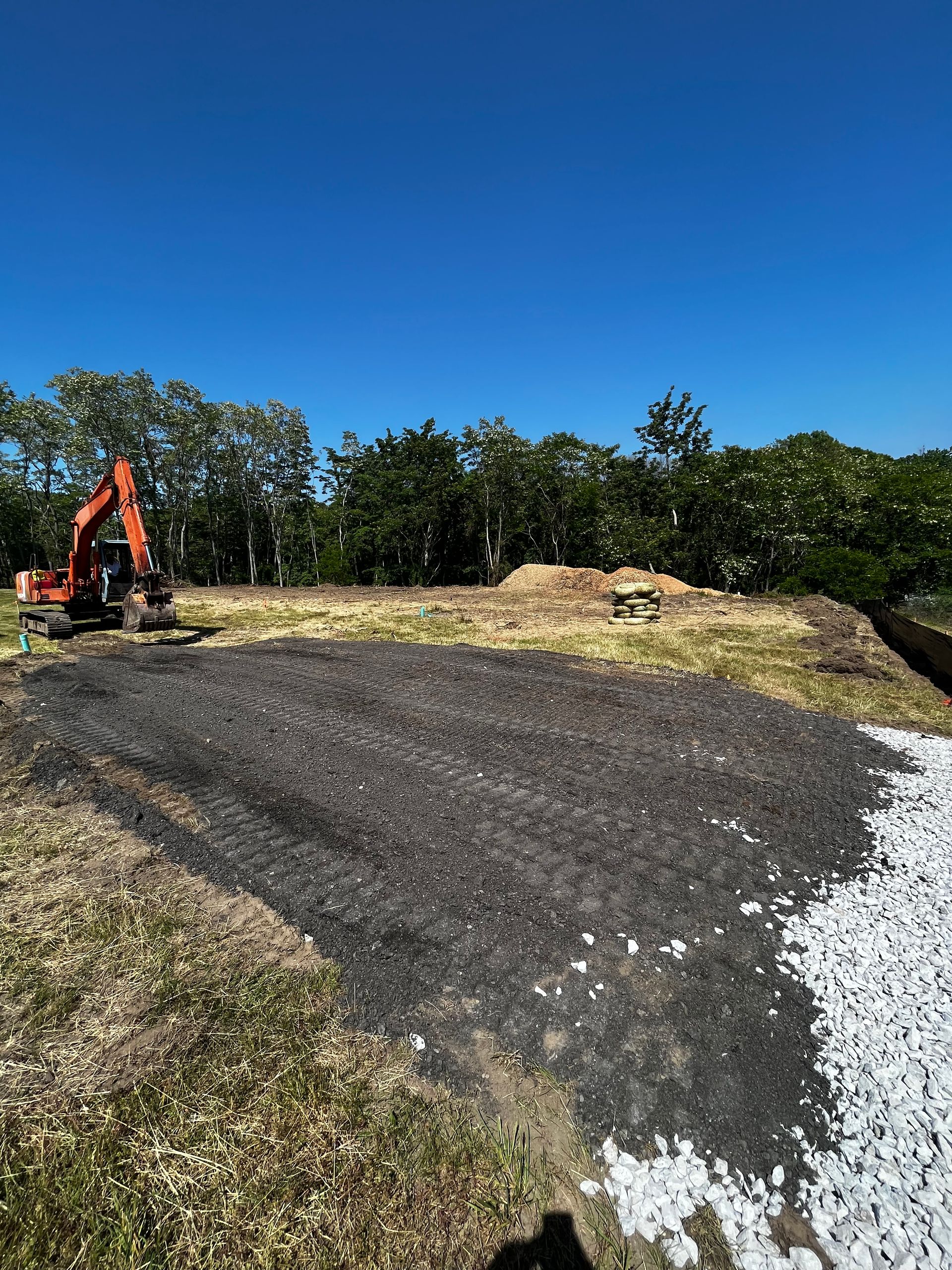 A bulldozer is digging a hole in the ground in a field.