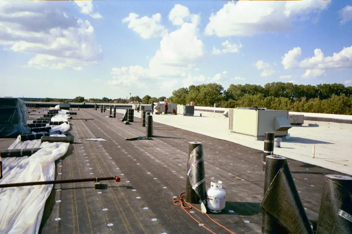 The roof of a building with a propane tank on it
