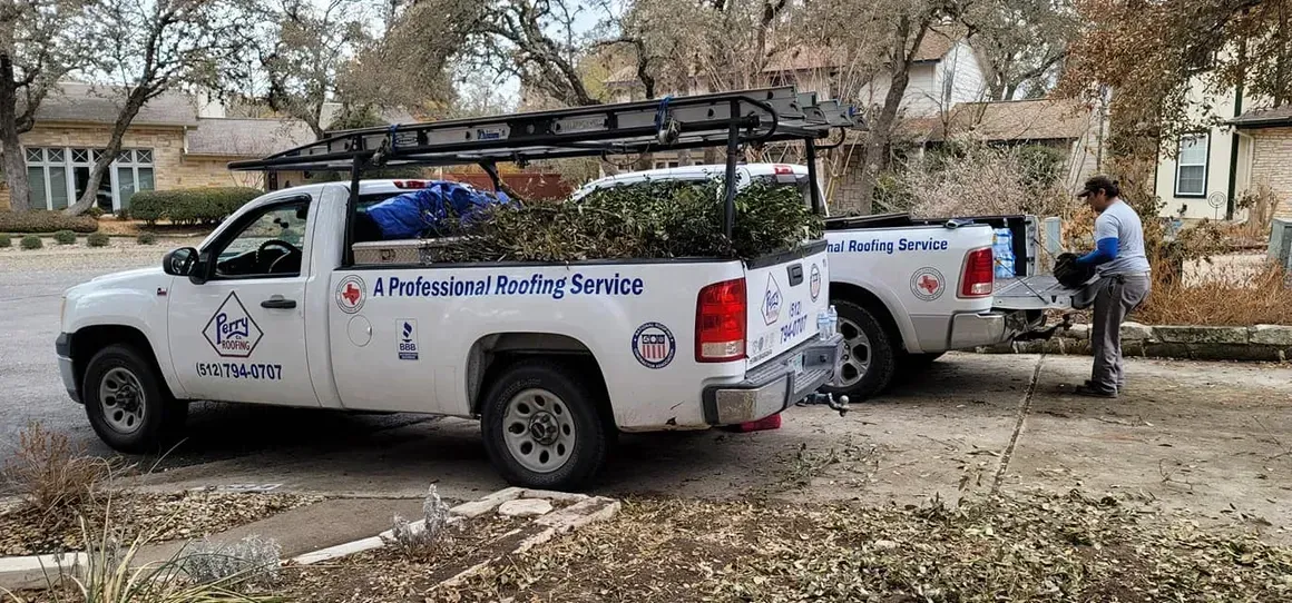 Two pickup trucks are parked next to each other on the side of the road.