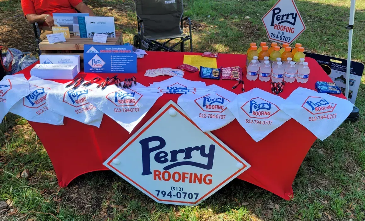 A table with a sign that says perry roofing on it