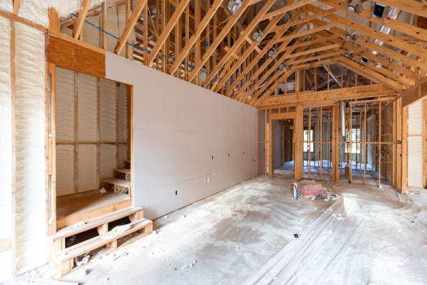 An empty room in a house under construction with a wooden ceiling
