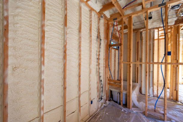 A room in a house under construction with foam insulation on the walls