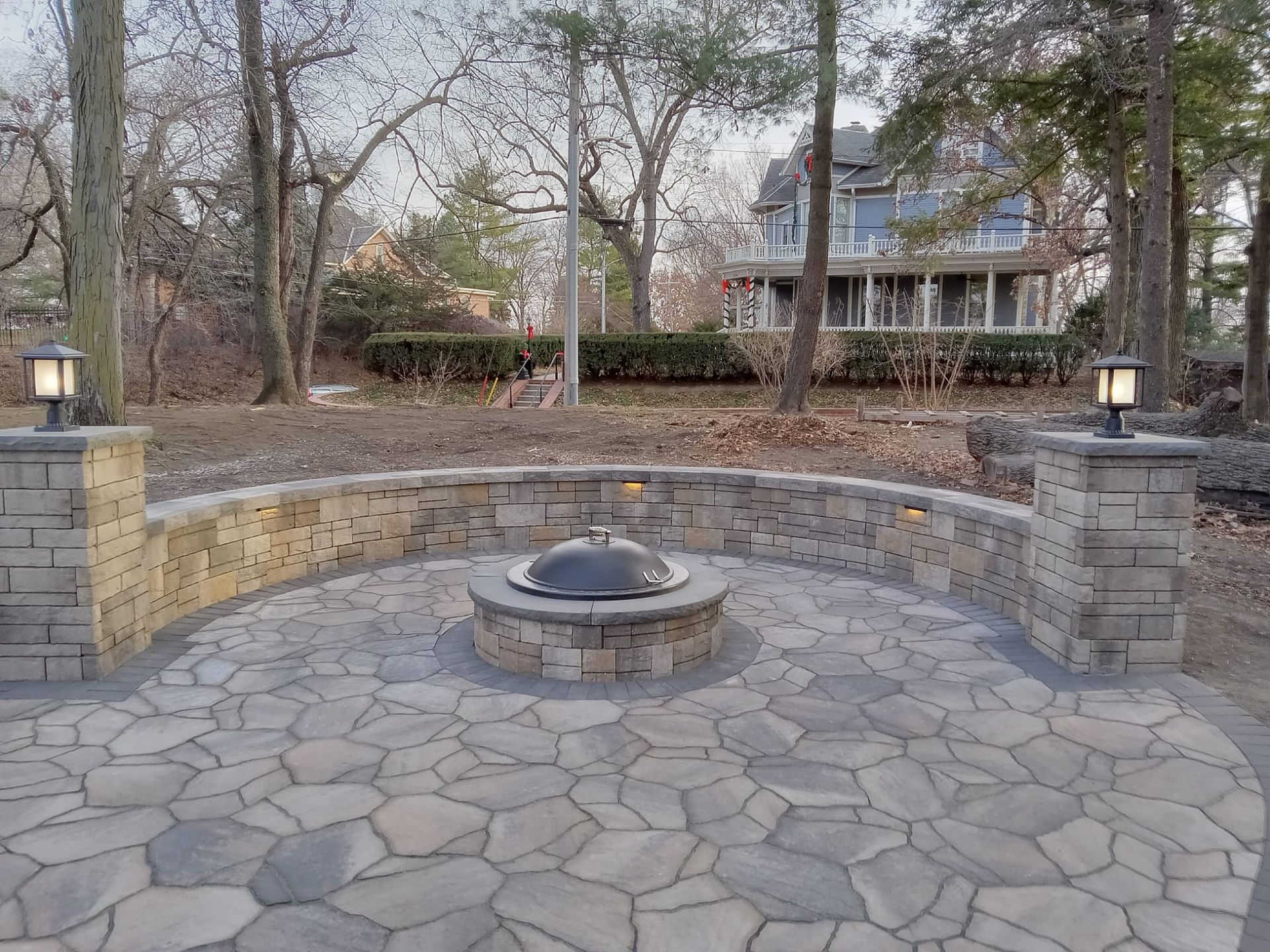 There is a fire pit in the middle of the patio
