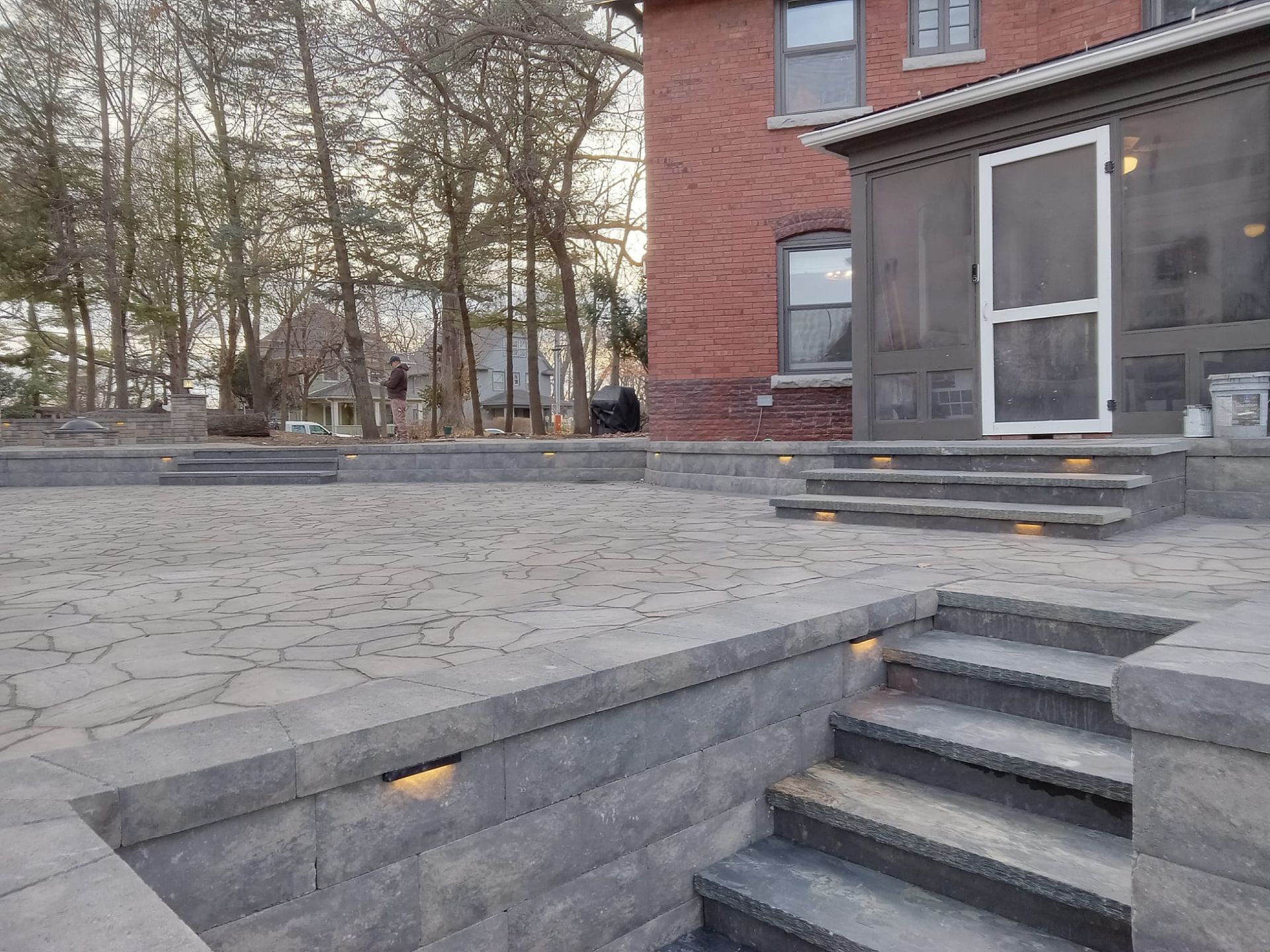 A house with a screened in porch and stairs leading to it