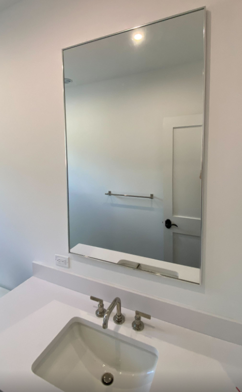 A bathroom sink with a large mirror above it.