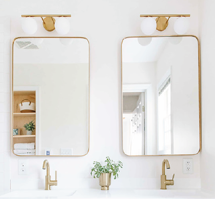 A bathroom with two mirrors and two sinks