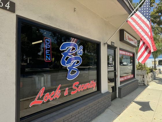 A storefront with an American flag hanging from the window.