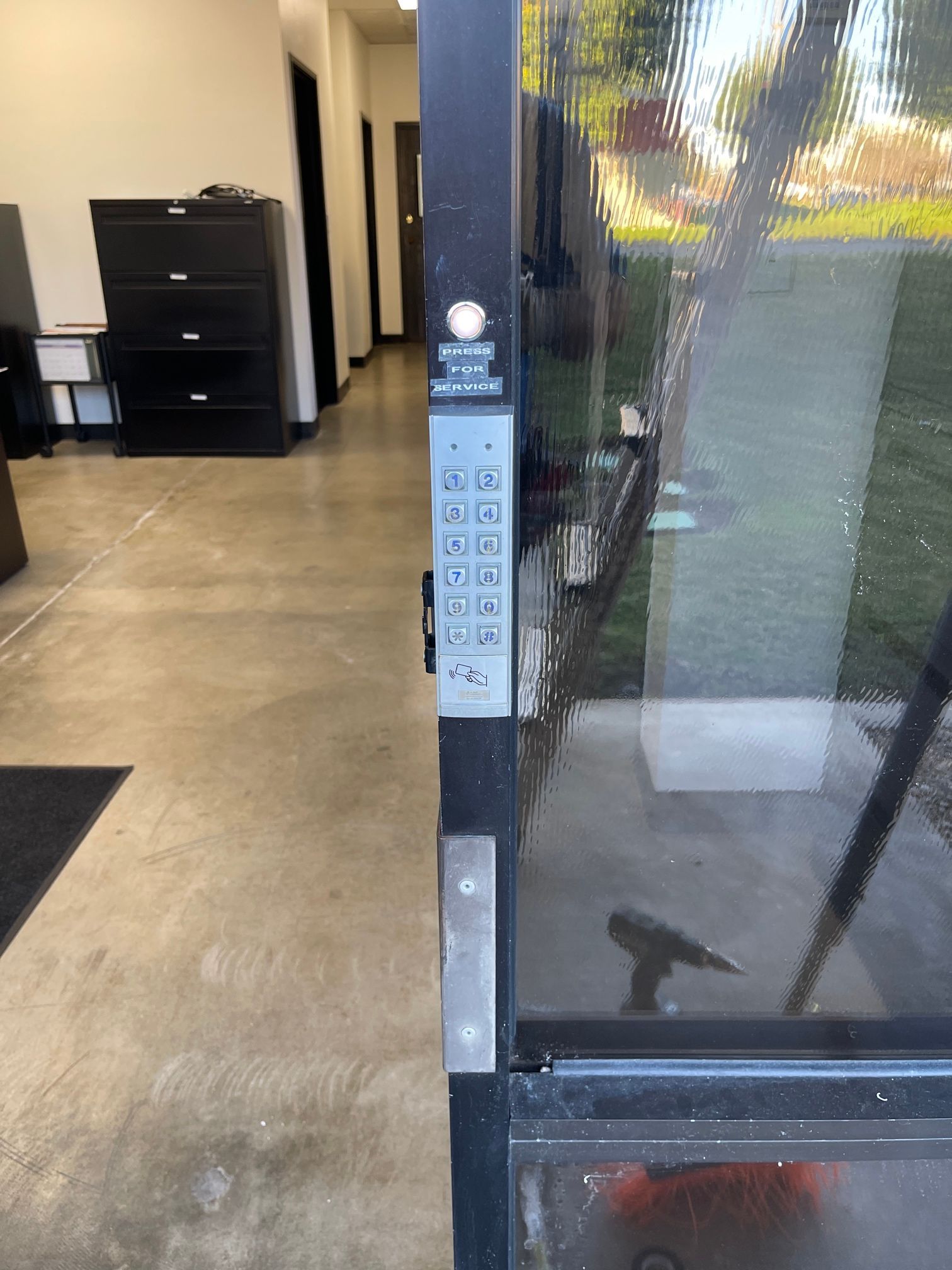 A black door with a keypad on it